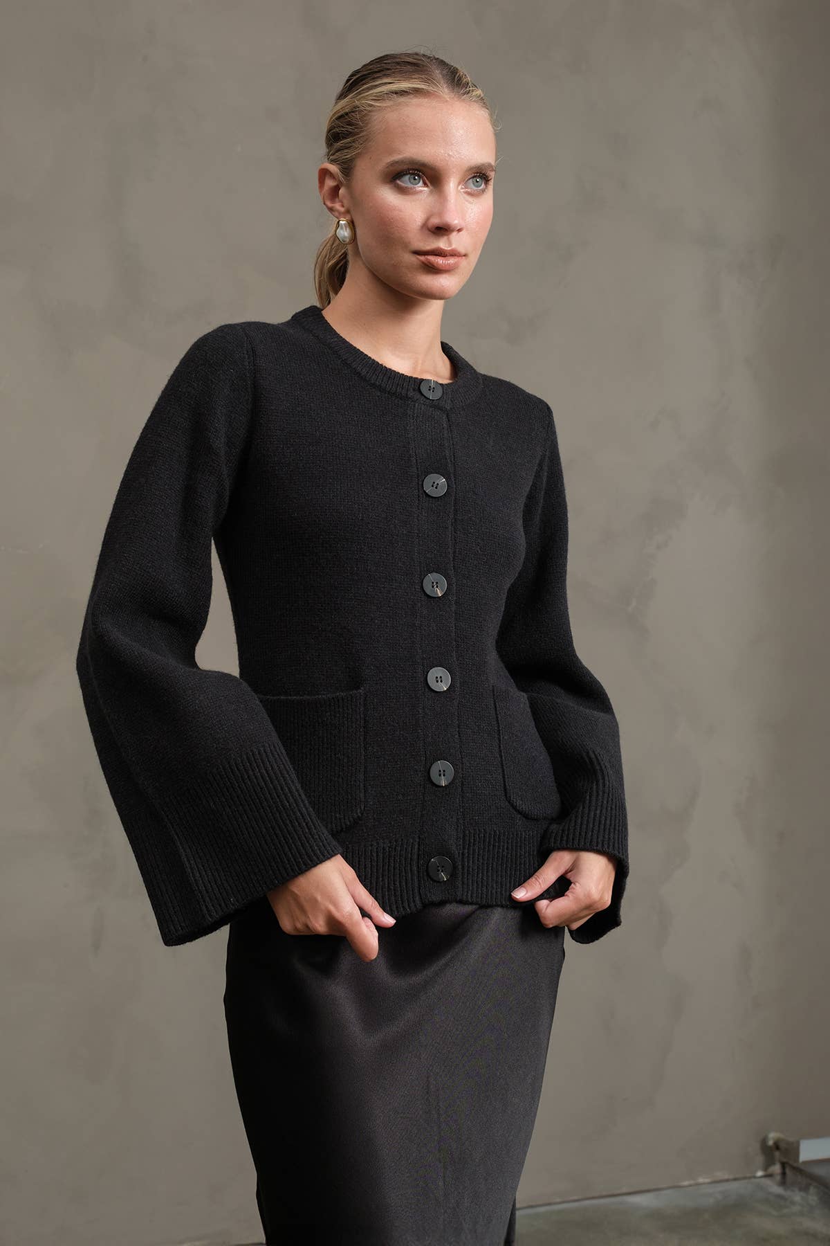 Black knit cardigan with bell sleeves styled on model