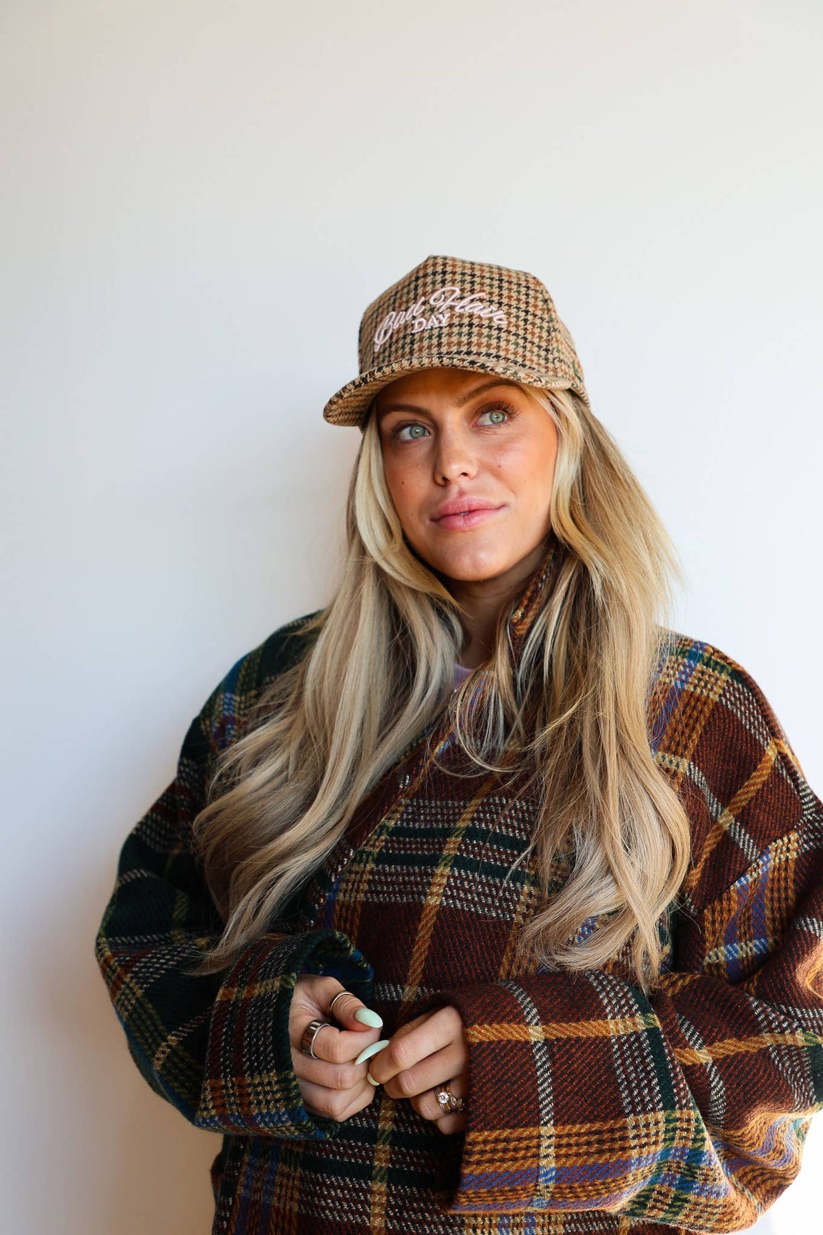 Brown houndstooth tweed trucker hat styled on model
