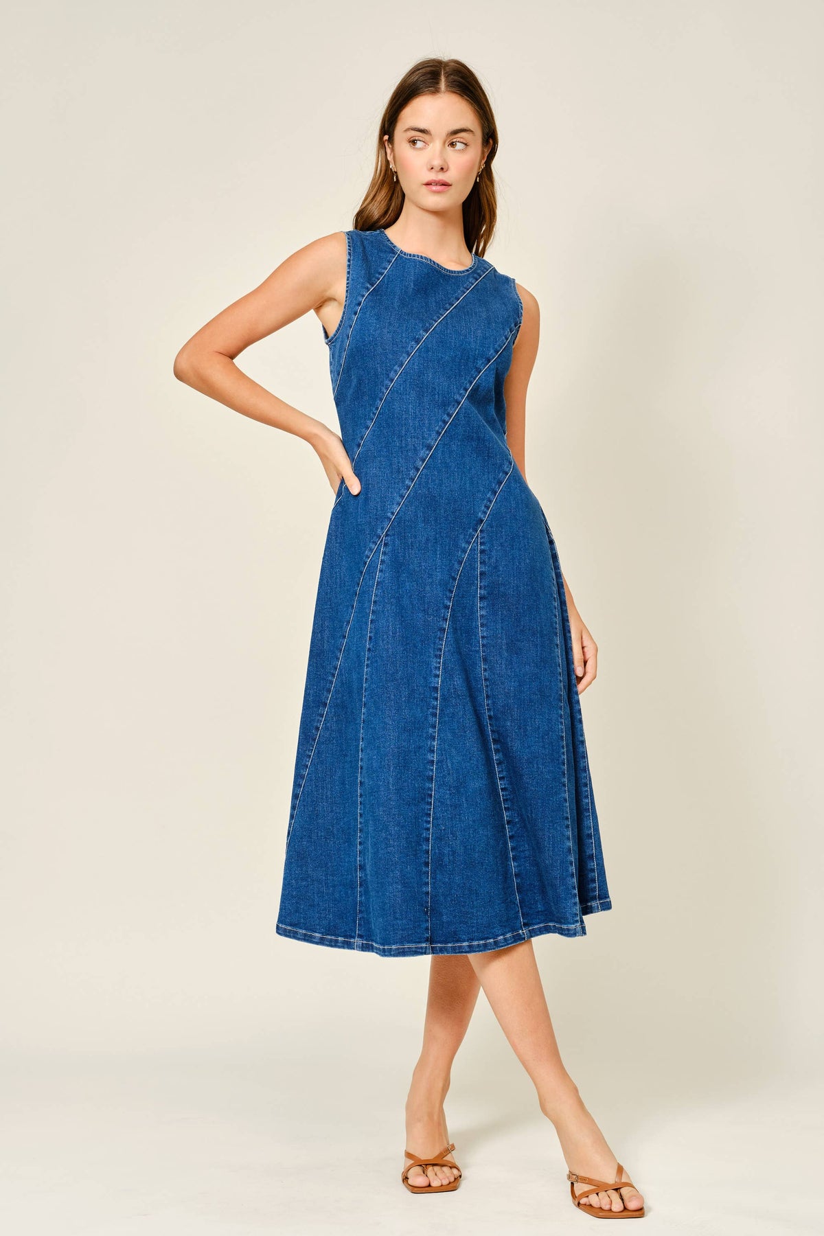 Dark denim midi dress with fitted bodice styled on model