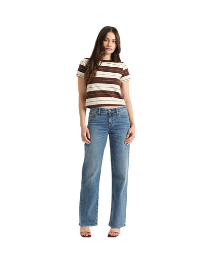 Woman wearing a striped shirt and jeans on a white background