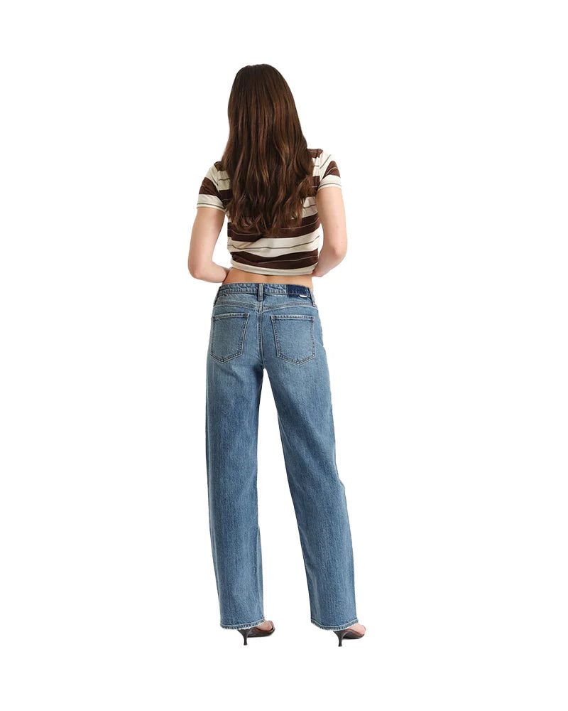 Person wearing blue jeans and a striped shirt from behind on a white background