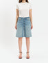 Person wearing a white t-shirt and light blue denim shorts on a white background