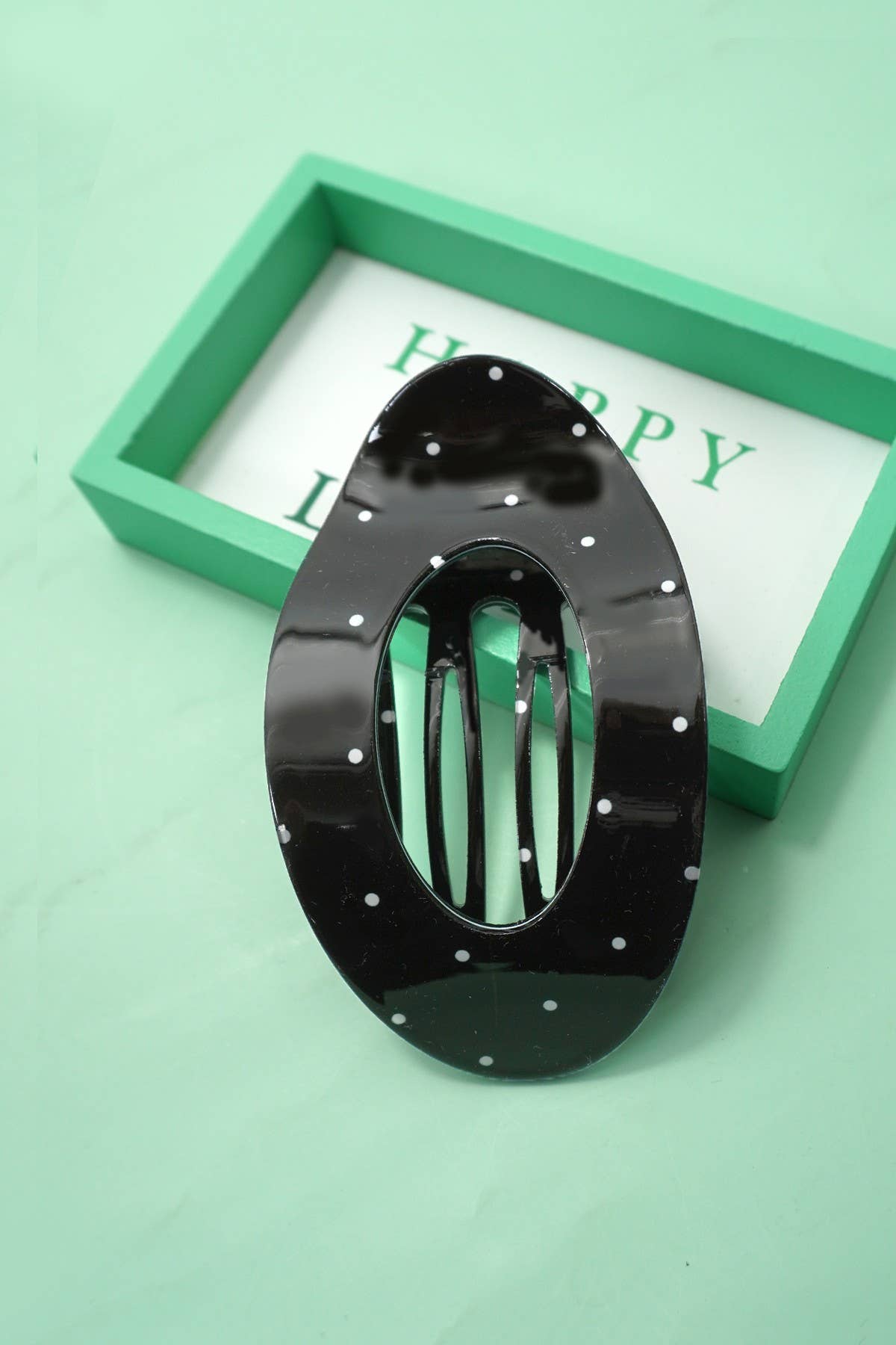 Lay flat polka dot hair claw clip styled in hair