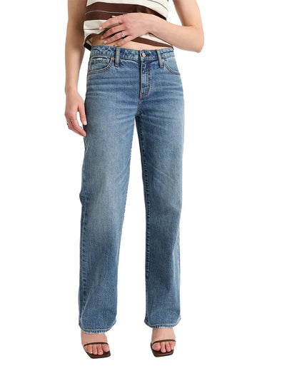 Person wearing blue jeans on a white background